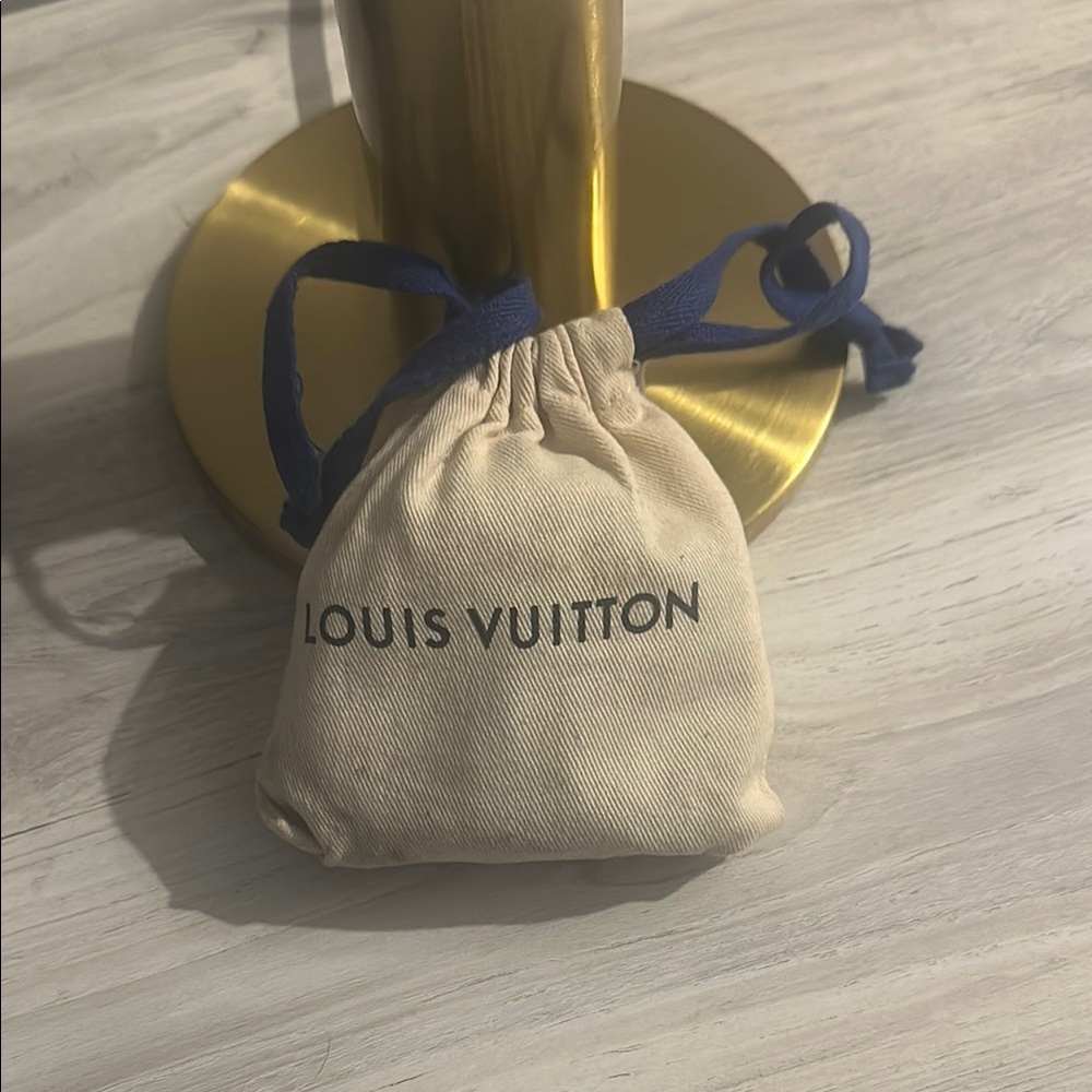 Barely used LV wireless headphones with charging case.